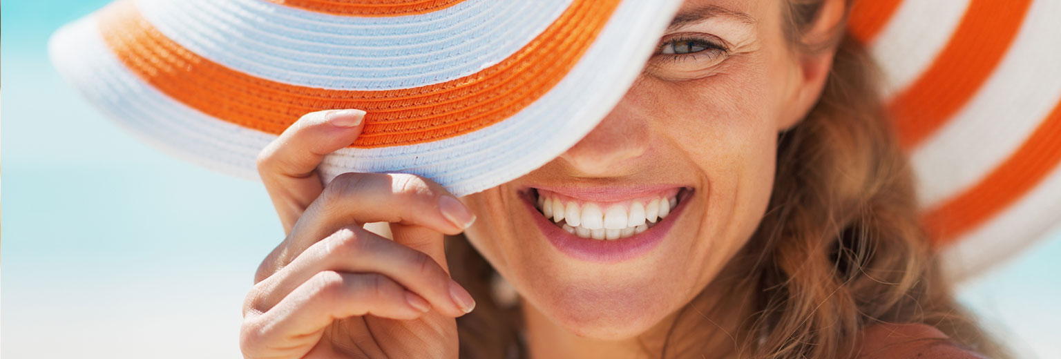 Woman Smiling After Sun Care Treatment